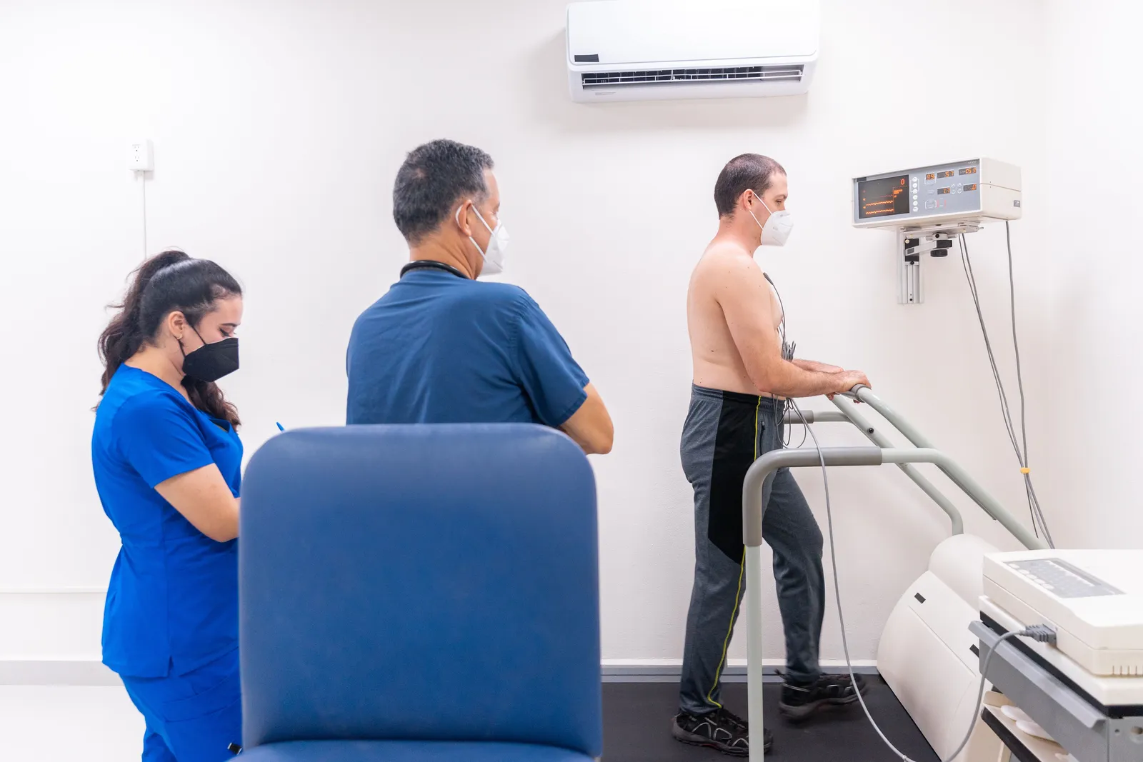Patient walking on a treadmill during a supervised cardiac stress test
