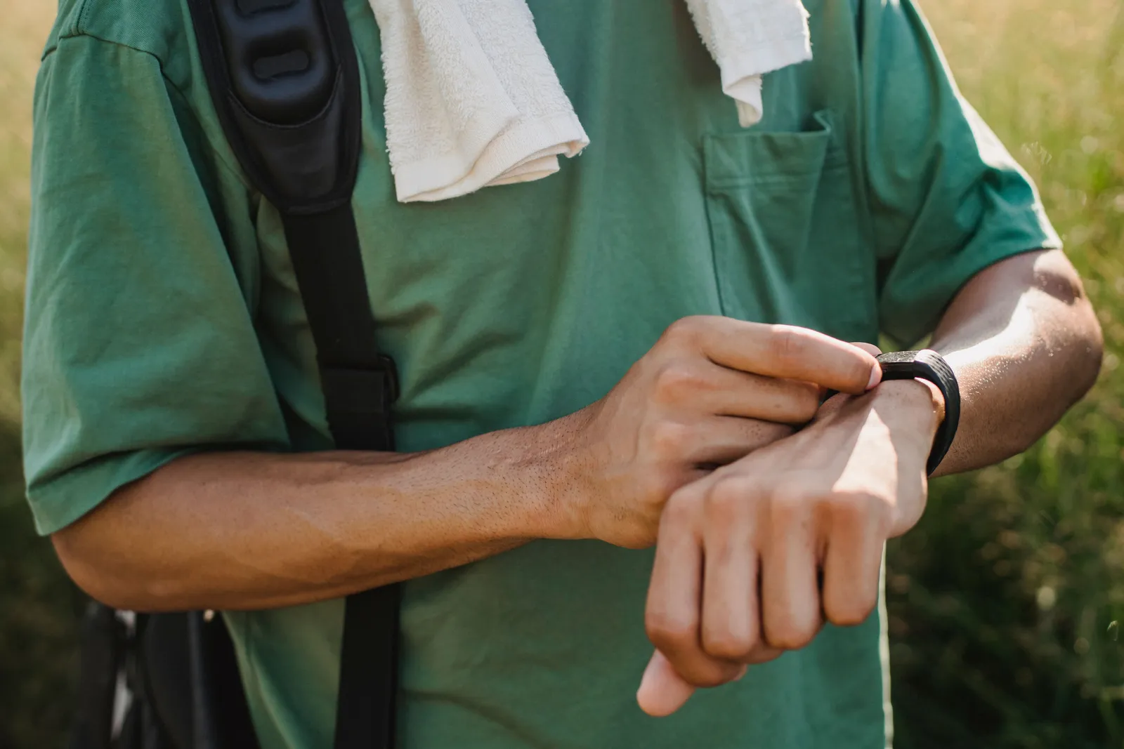 Man checking a smartwatch on his wrist outdoors